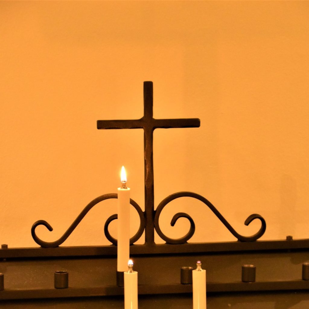 A cross with candles in a church